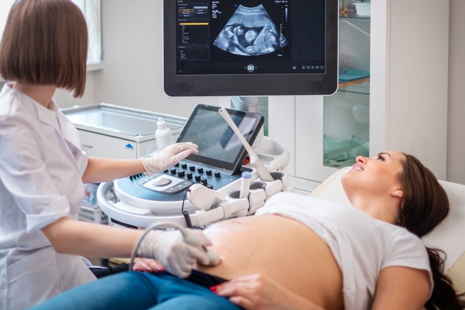 Médica realizando ultrassom obstétrico em gestante
